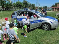 Policjanci z dziećmi o tym jak bezpiecznie spędzić wakacje