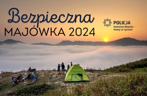 Na zdjęciu w górskim krajobrazie namiot i grupa osób oraz motocykli. Na górze napis o treści Bezpieczna Majówka 2024